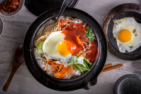 Bibimbap - Korean hot pot with rice and fried eggの写真素材