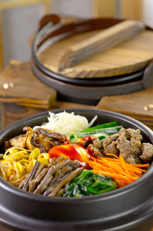 Noodles with beef and vegetables in a bowl on the tableの写真素材
