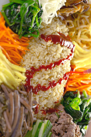Rice with kimchi and vegetables on plate, closeupの写真素材