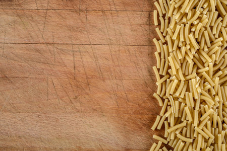 Raw pasta on wooden background. Top view with copy space for your text.の写真素材