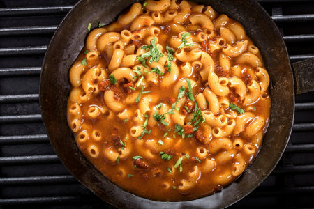 Pasta with tomato sauce and parsley in a cast iron skilletの写真素材