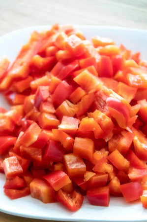 Red paprika sliced on white plate for healthy eating. Close up.