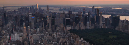 New York City Manhattan skyline panorama at sunset with skyscrapers.