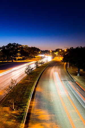 Light trails on the road at night. Motion blur of car lights.の写真素材