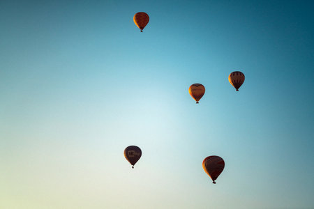 Hot air balloons flying in the sky at Cappadocia, Turkeyの写真素材