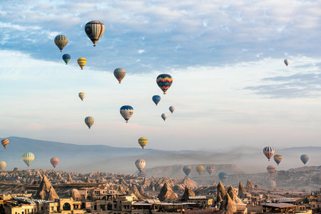 Hot air balloons flying over the city of Cappadocia, Turkeyの写真素材