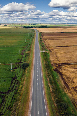 Aerial view of the road in the field. View from above.