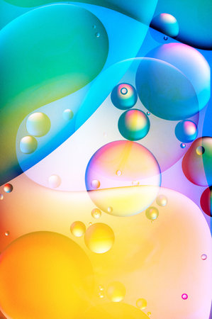 bright oily drops in water with colorful background, closeup of photoの写真素材