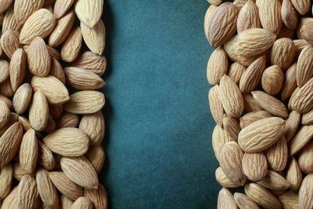 Almond nuts on a dark blue background. Close-up.の写真素材