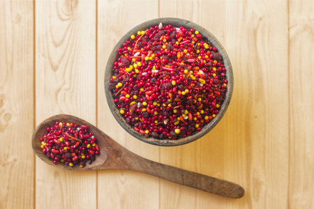 Bowls of colorful sprinkles on a wooden background, top view