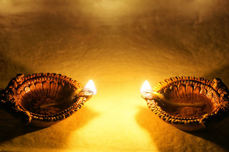 Happy Diwali - Clay Diya lamps lit during Diwali celebration.