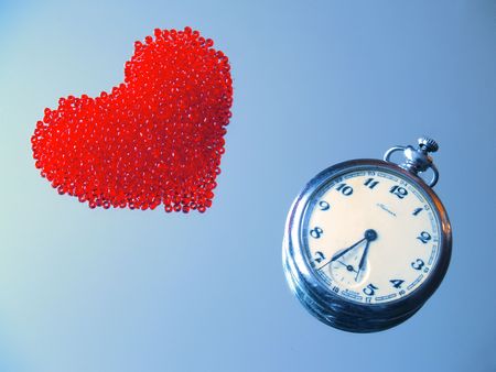 clock and glass beads heart on the mirrorの写真素材