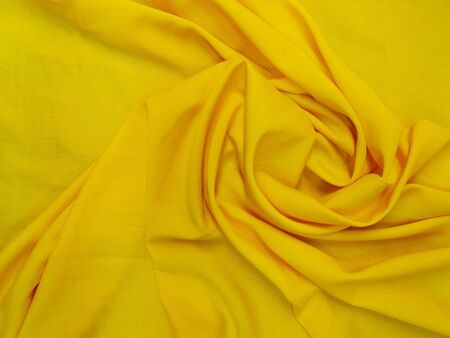 yellow fabric with beautiful foldsの写真素材
