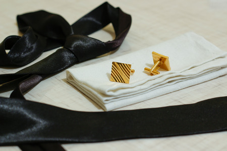 Set for men. For a classic suit. Black tie, white linen handkerchief, gold cufflinks.の写真素材