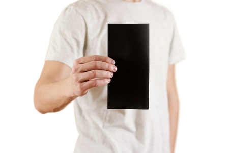 Man showing blank black flyer brochure booklet. Leaflet presentation. Pamphlet hold hands. Man show clear offset paper. Sheet template. Booklet design sheet display read first person. On white background.の写真素材