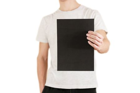 Man holding black A4 paper vertically. Leaflet presentation. Pamphlet hold hands. Man show clear...