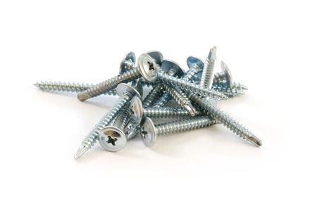 Set of metal screws on the white backgroundの写真素材