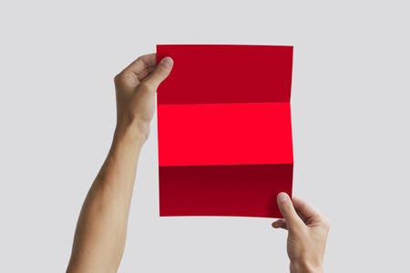 Hand holding blank brochure booklet in the hand. Leaflet presentation. Pamphlet hand man. Man show offset paper. Sheet template. Book in hands. Booklet folding design. Fold paper sheet display read.の写真素材