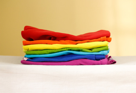 Stack of ironed colored linen. Pile of clothes. Ironing concept. All colors of the rainbowの写真素材