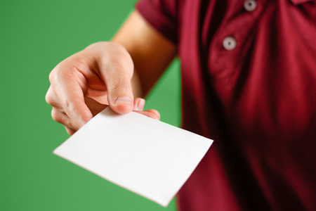 Man showing blank white square flyer brochure booklet. Leaflet presentation. Pamphlet hold hands....