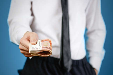 Closeup of businessman holds money. Banknotes Of Russia. Isolated.の写真素材