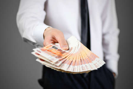 Closeup of businessman holds money. Banknotes Of Russia. Isolated.
