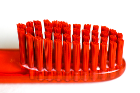 Orange toothbrush. Macro. Closeup. Isolated on a white background.の写真素材