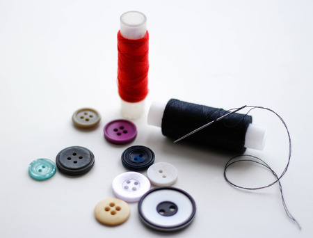 Buttons and skeins of thread. Closeup. Isolated on a white background.