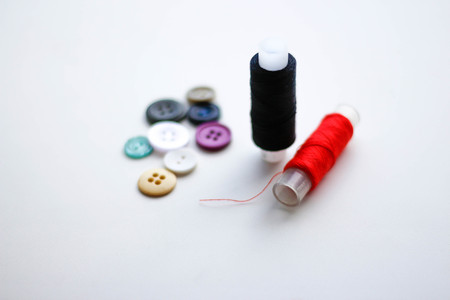 Buttons and skeins of thread. Closeup. Isolated on a white background.