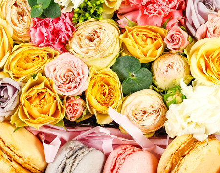 Flowers and cookies in a box. Rocket in a hatbox. Close up. On a white background.の写真素材