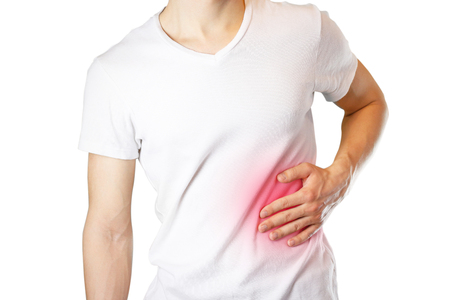 A man holds the liver. Pain in the abdomen. Cirrhosis of the liver. Sore point highlighted in red. Closeup. Isolated on white background.の写真素材