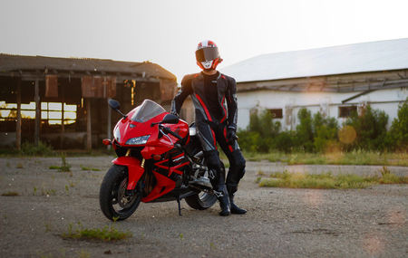 KRASNOYARSK, RUSSIA - June 23, 2018: Beautiful motorcyclist in full gear and helmet on a red and black Honda 2005 CBR 600 RR (PC37)のeditorial素材