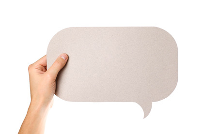 Hand holding an empty speech bubble. Close up. Isolated on white background.の写真素材