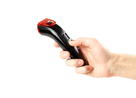 Hand holding black beard hair trimmer. Close up. Isolated on white background.