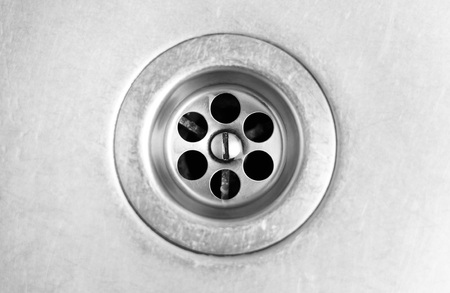 Drain hole in metal sink. Close up.の写真素材