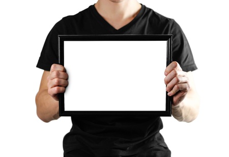 A man holds a black A4 frame. An empty frame with a white background. Close up. Isolated on white background.の写真素材