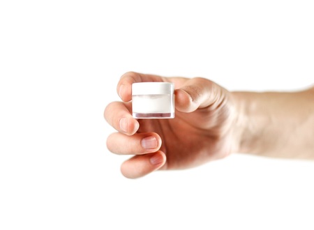 Hand holding white lip balm. Close up. Isolated on white background.の写真素材