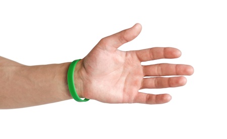 Colored rubber bracelets on the arm. Close up. Isolated on white background.の写真素材