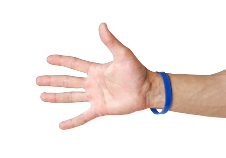 Colored rubber bracelets on the arm. Close up. Isolated on white background.