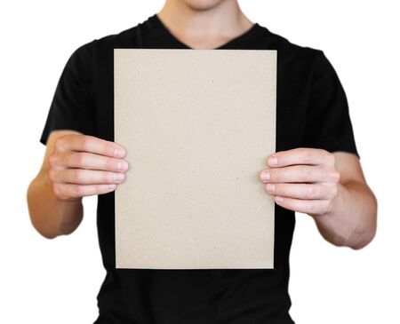 A man holding a white sheet of paper. Holding a booklet. Close up. Isolated on white background.の写真素材