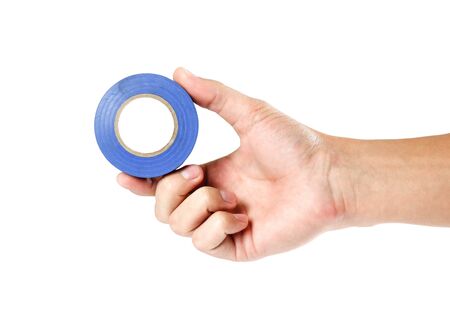 Hand holding blue insulation tape. Close up. Isolated on white background.の写真素材
