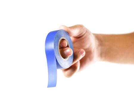 Hand holding blue insulation tape. Close up. Isolated on white background.の写真素材