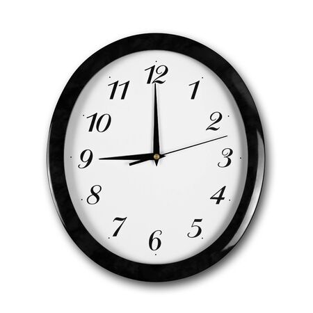 Large round white wall clock with black frame. The hands point to 9 o'clock. Close up. Isolated on white background.の写真素材