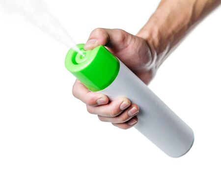 Hand holding green air freshener. Close up. Isolated on white background.の写真素材