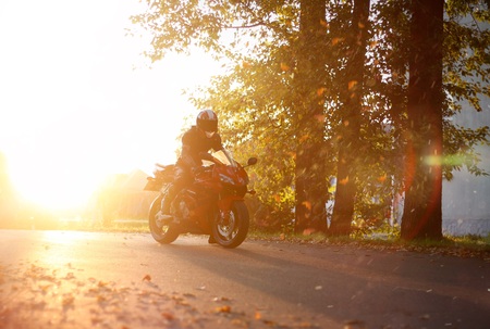 KRASNOYARSK, RUSSIA - August 27, 2019: Beautiful motorcyclist in full gear and helmet on a red and black Honda 2005 CBR 600 RR (PC37).のeditorial素材