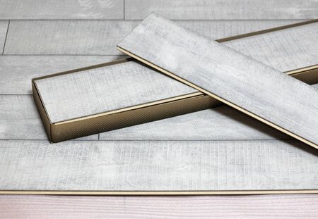 Laying laminate. Substrate under the laminate, a pack of lamellas, laminate. Close up.
