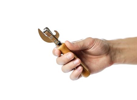 Hand holding universal opener for cans and beer bottles. Close up. Isolated on white background.の写真素材