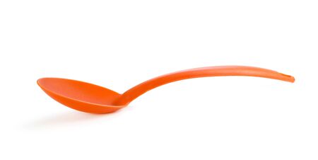Red plastic ladle. Close up. Isolated on white background.の写真素材