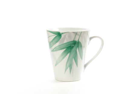 White mug with a picture of green leaves. Close up. Isolated on white background.の写真素材