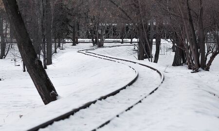 The winding railway. Snowy railroad tracks.